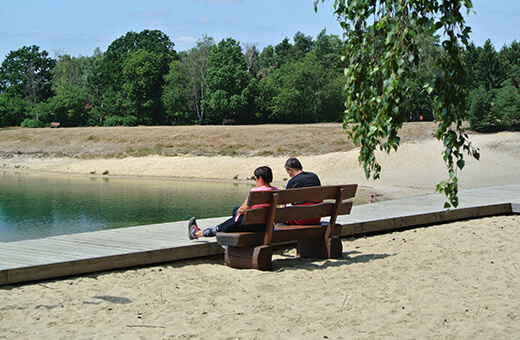 Wanderer Paar sitzt auf einer Bank an der Strandpromenade