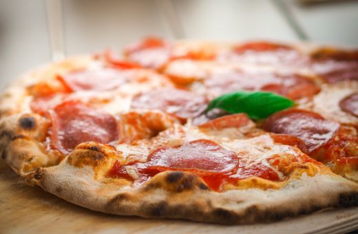 pizza Mann genießt den Sommer auf der Terrasse am Strand